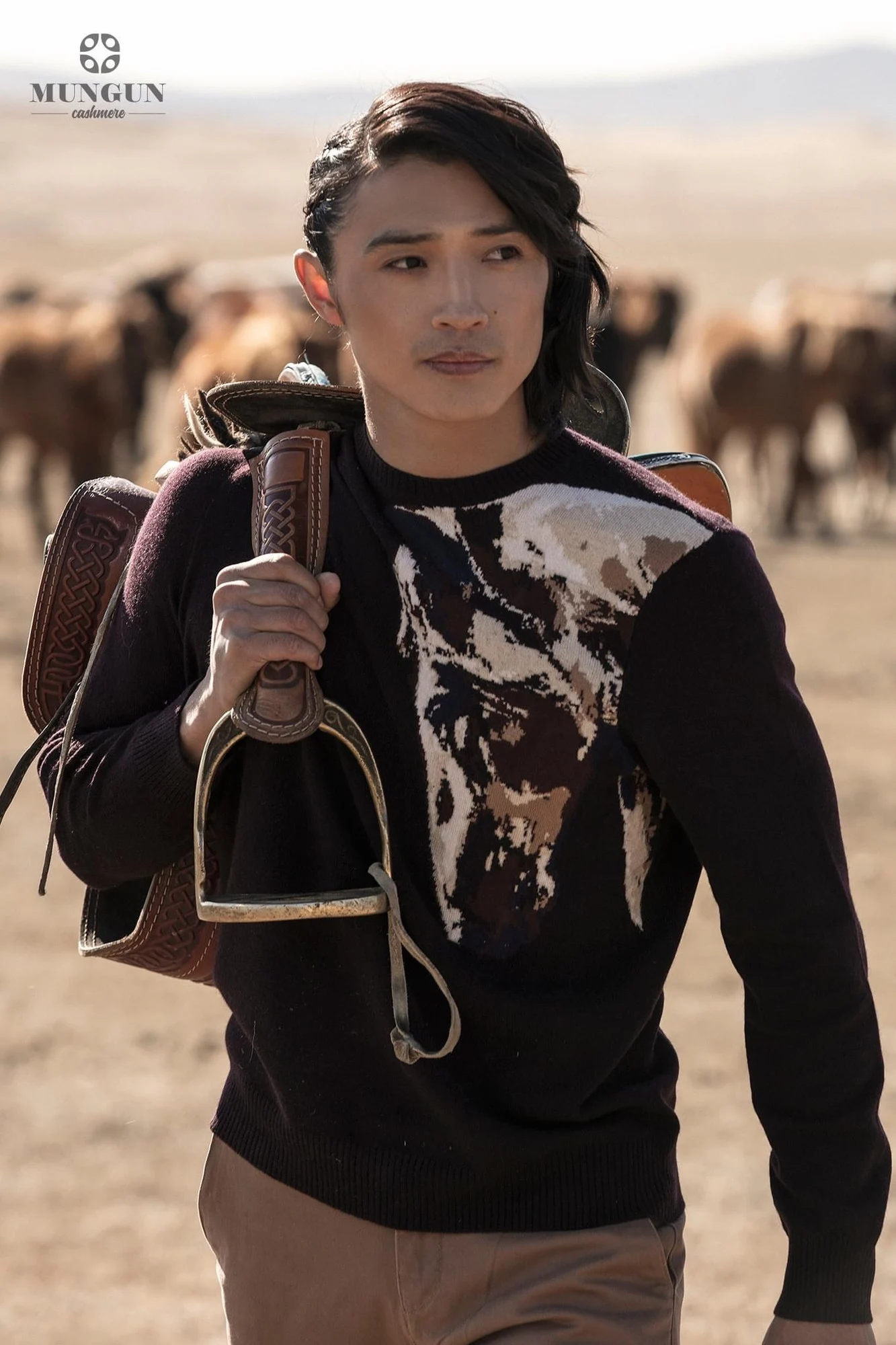 Ochir in a patterned cashmere sweater with sheep on the Mongolian steppe