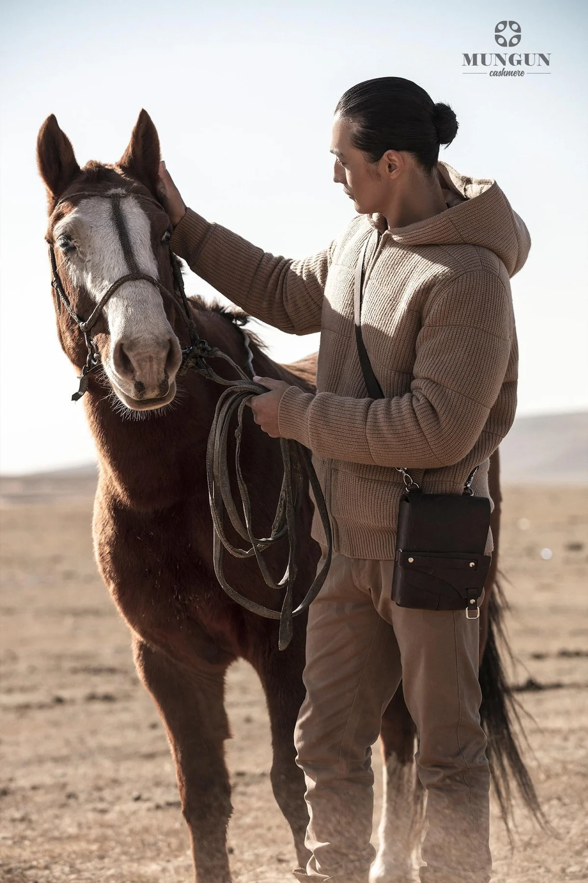 Ochir photographed with a horse in the Mungun Cashmere campaign