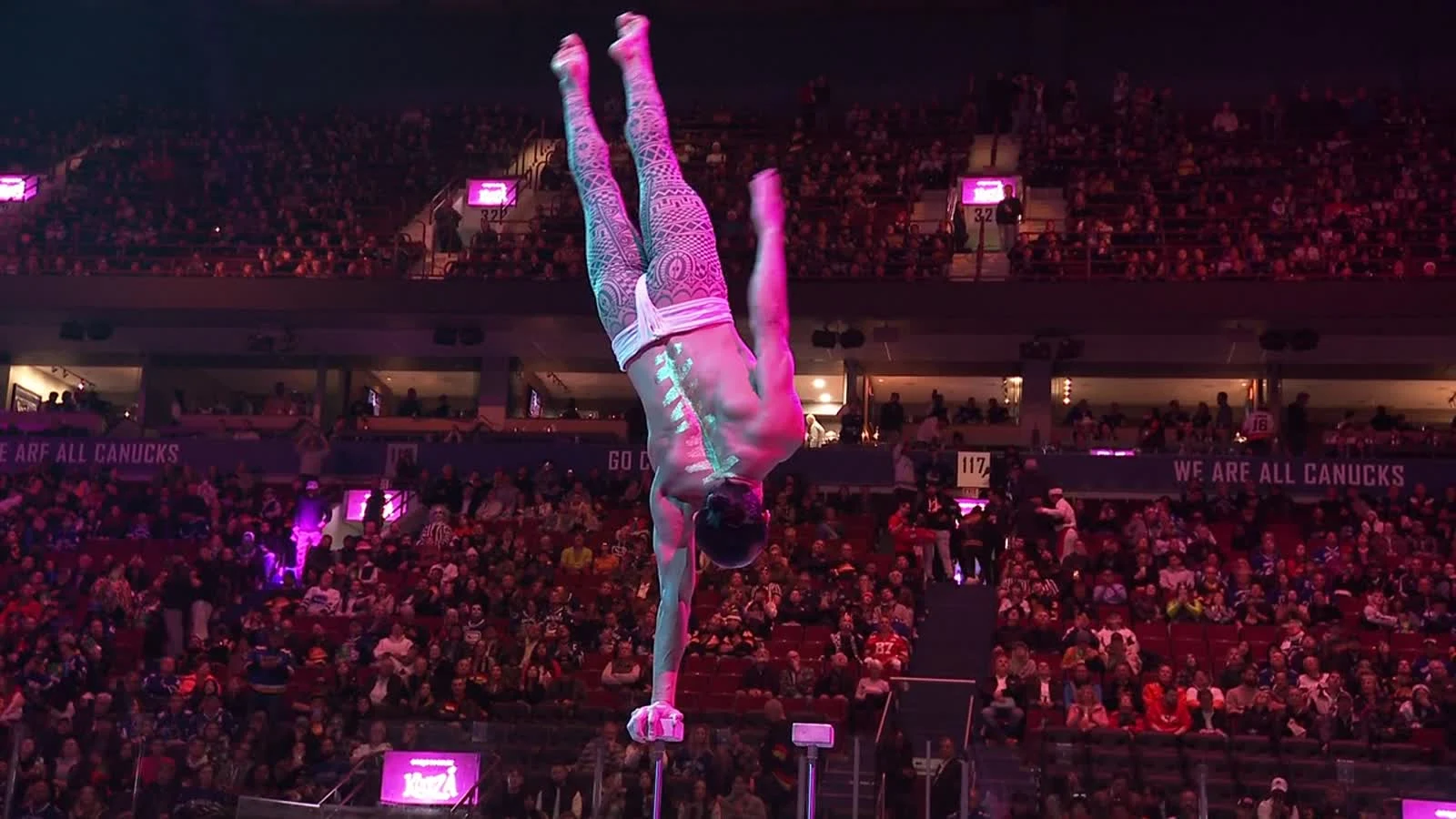 Ochir performing a one-arm balance in CRYSTAL, in a real frame from the film