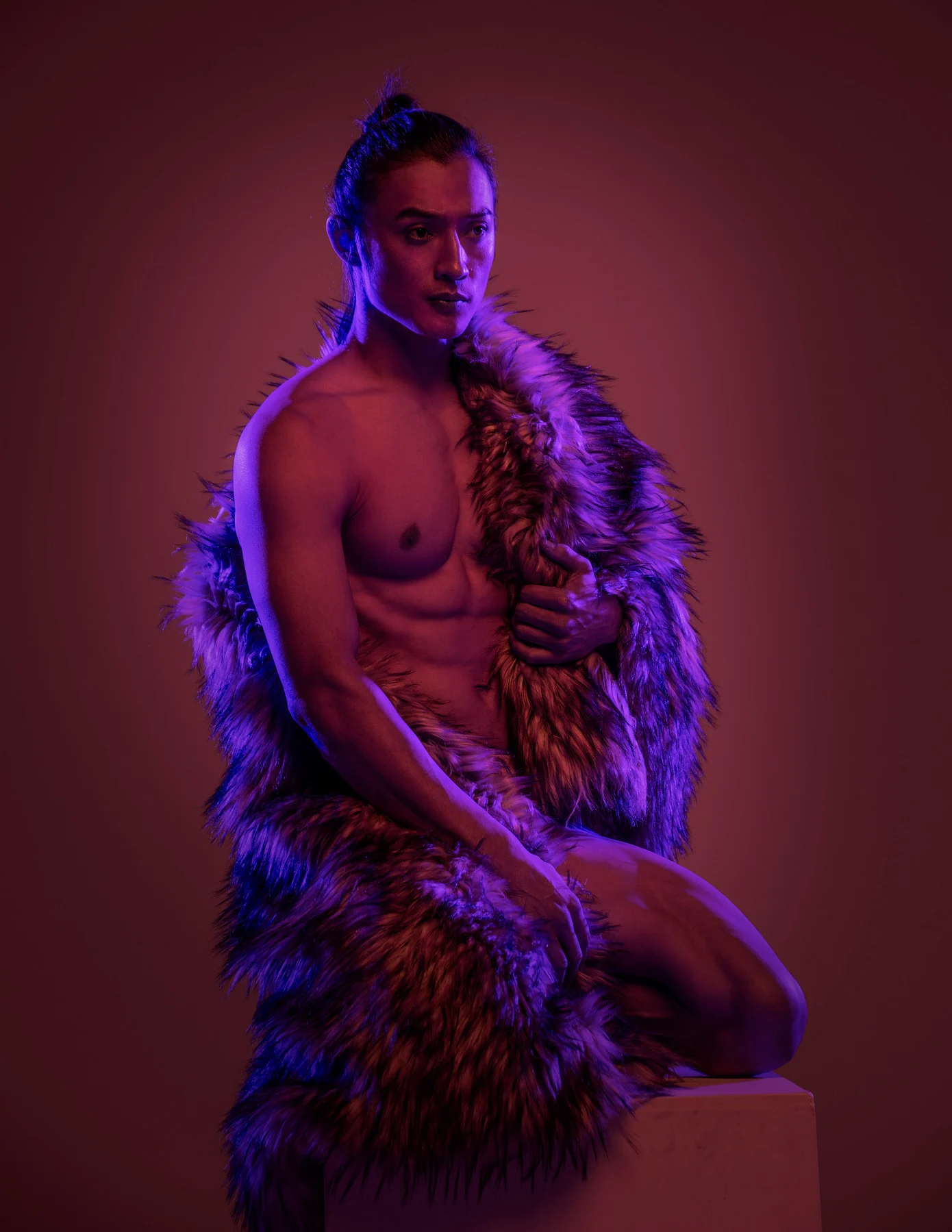 Ochir photographed under purple and amber studio light