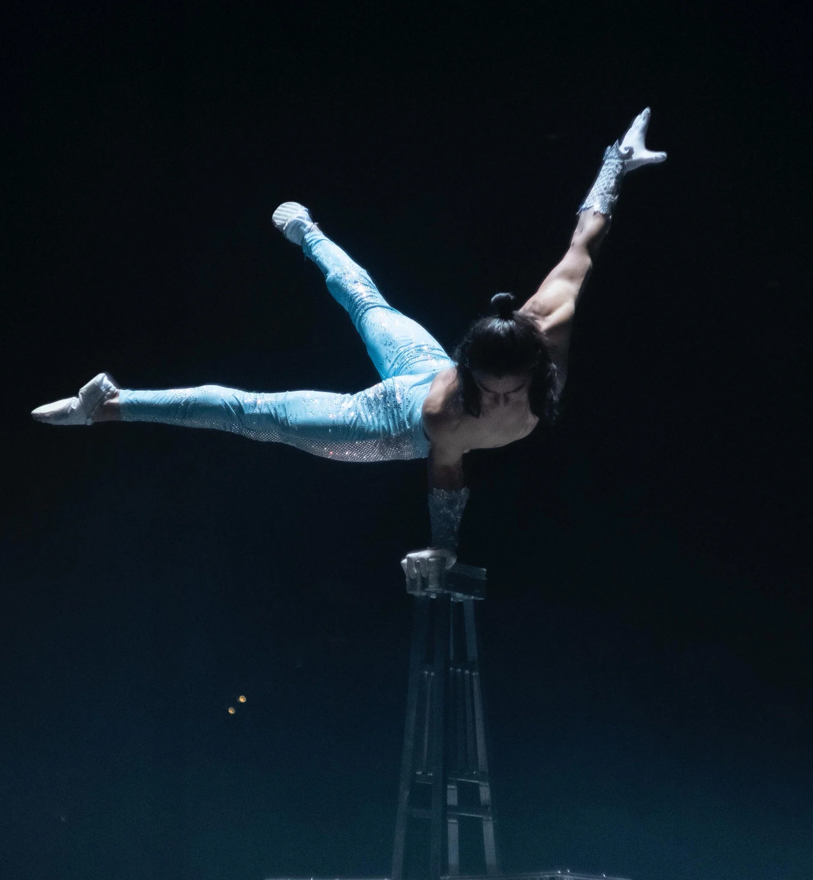 Ochir performing his signature chair balancing act in a silver costume