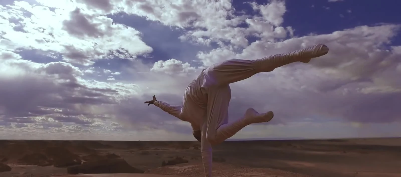Ochir hand balancing in the Gobi landscape, in a real frame from Well Balanced