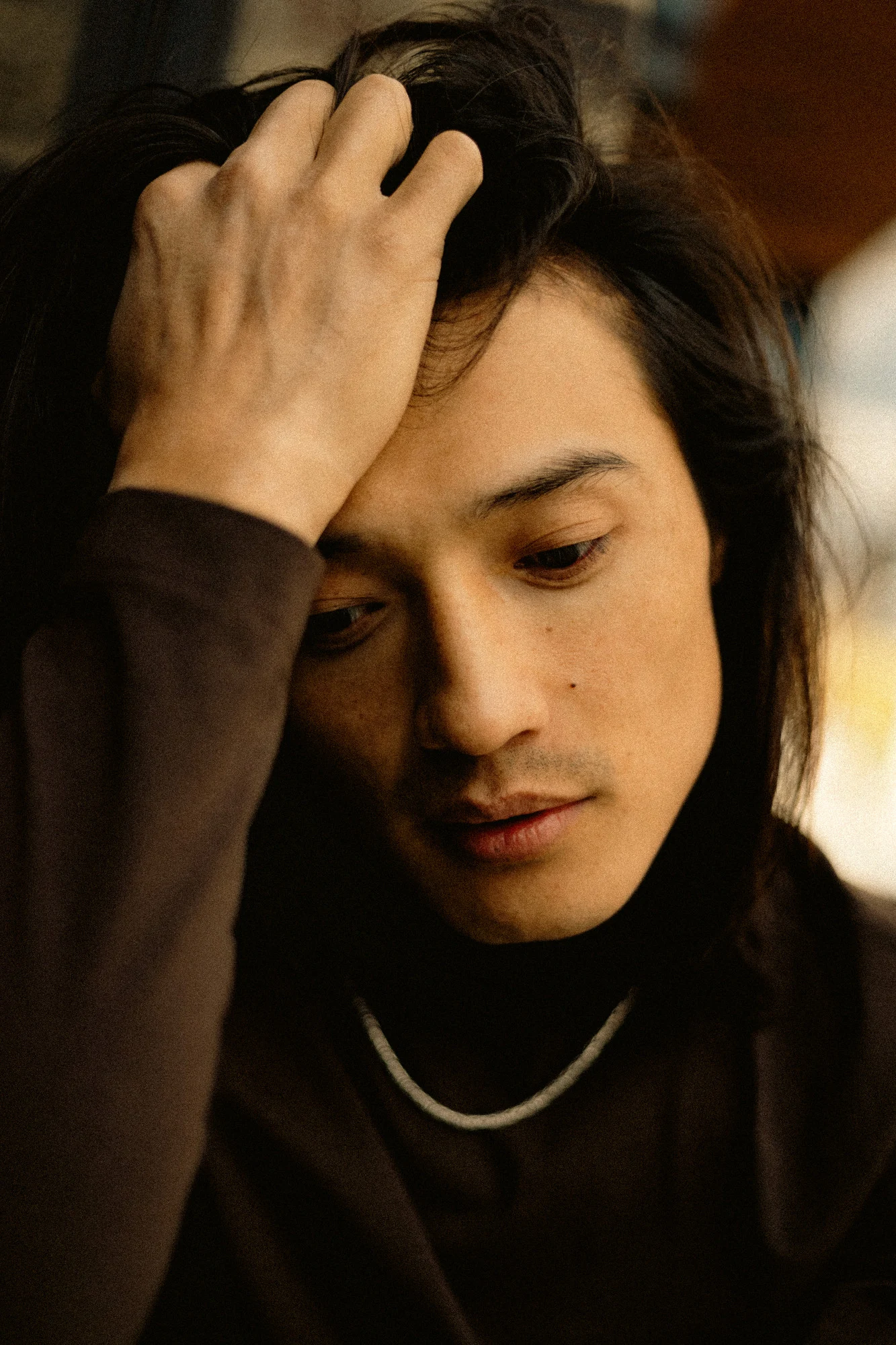 Close portrait of Ochir with his hand resting in his hair