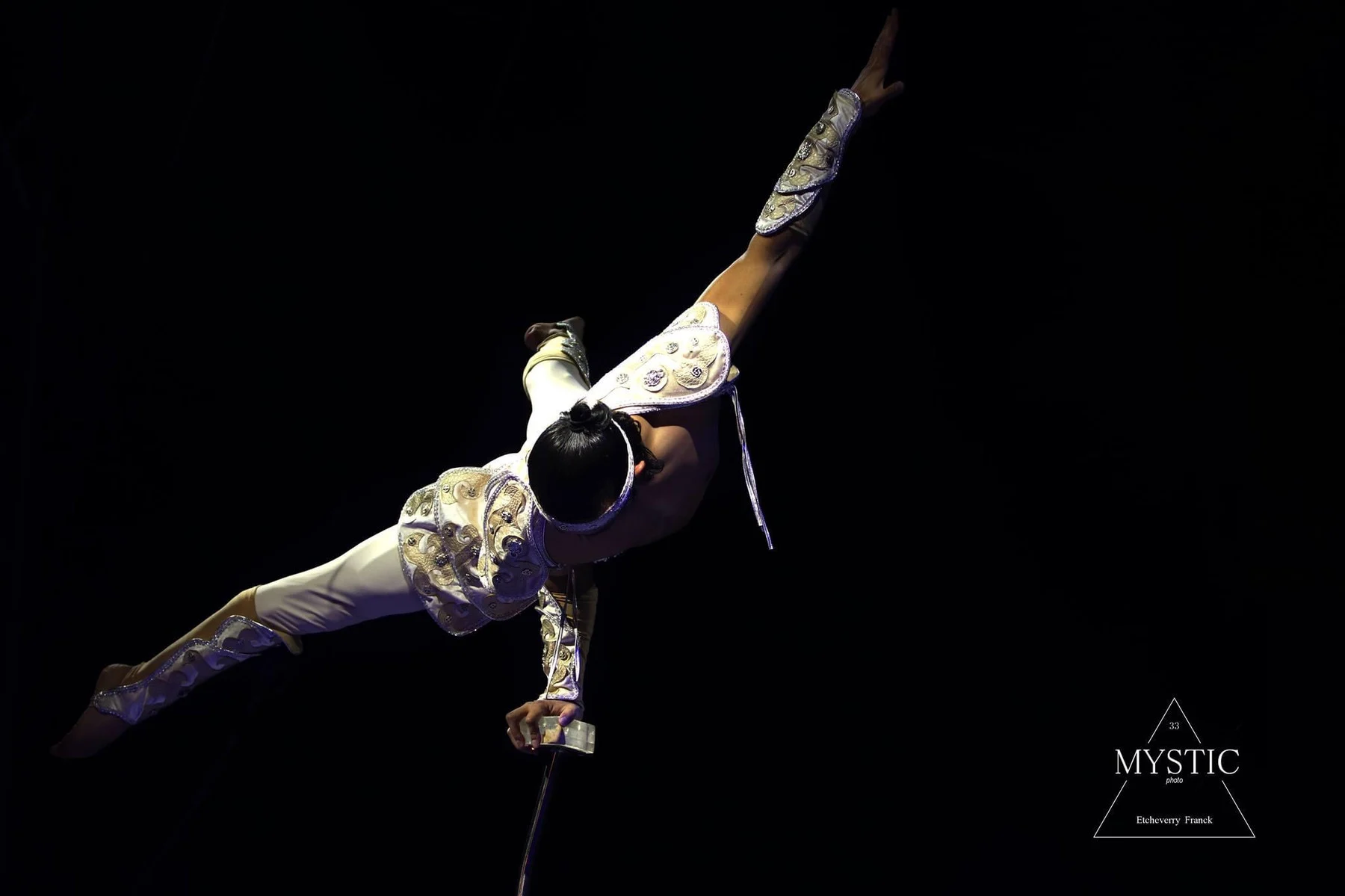 Ochir extending his body in a one-arm hand balance